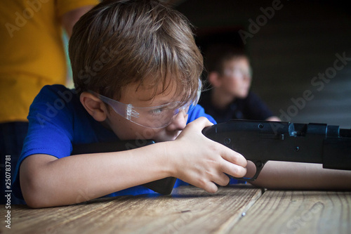 boy aiming rifle