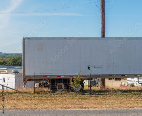 18 wheeler big rig parked on side of rural road with space for type