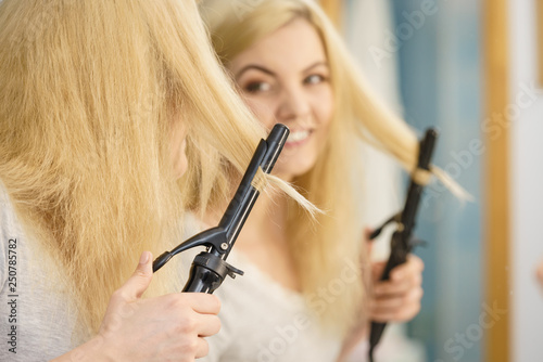 Woman using hair curler