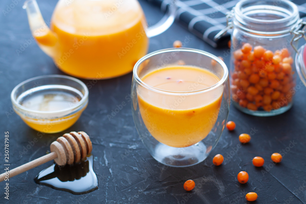 Sea buckthorn tea close up. Hot autumn beverage in a glass Sea buckthorn tea close up. Hot autumn beverage in a glass
