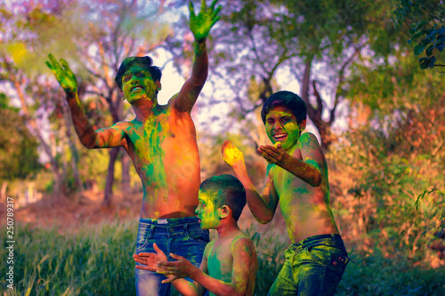 Indian child playing with the color in holi festival 