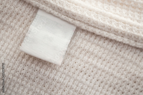 White blank clothing label on cotton shirt background