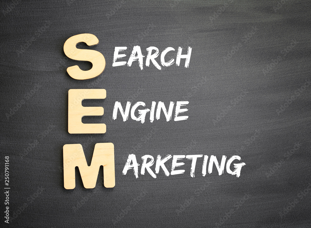 Obraz premium Wooden alphabets building the word SEM - Search Engine Marketing acronym on blackboard