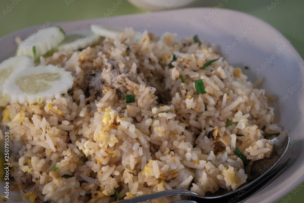 Fried rice with chicken. Prepared and served in a wok. Natural wood in the background. Top view. Fried rice with chicken. Prepared and served in a wok. Natural wood in the background. Top view.