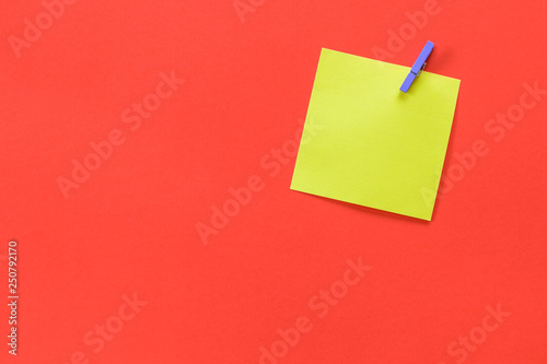 Yellow memo post with space for text isolated on a red background