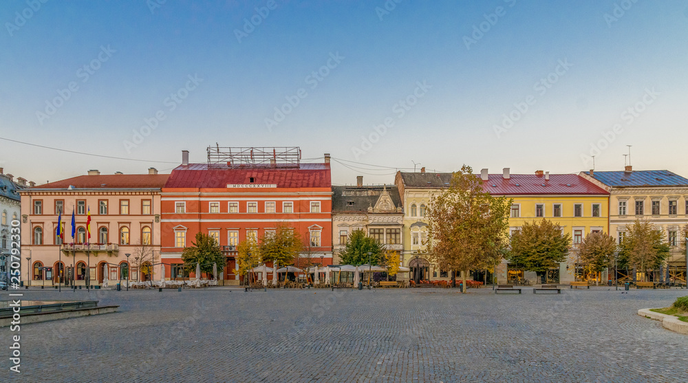 Cluj-Napoca city center. View from the Unirii Square to the Josika Palace, Rhedey Palace and Wass Palace at sunrise on a beautiful, clear sky day