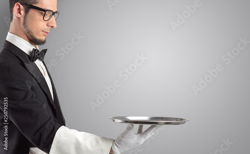 Waiter serving with white gloves and steel tray in an empty space
 photo