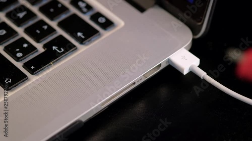 Close-up of a USB and HDMI cables being connected to computer.
