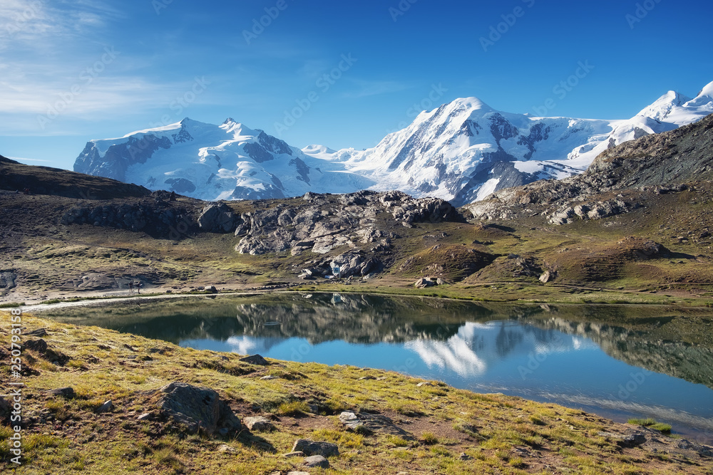 Mountain lake in Switzerland. High mountains region at the day time. Natural landscape in Swiss mountains. Switzerland landscape - image