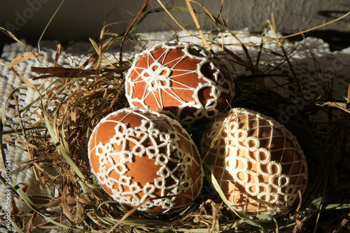 Handmade Easter Eggs decorated with lace tatting in a straw nest. Easter decoration 
