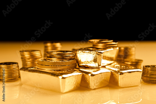 Gold bars and stack of gold coins. Background for finance banking concept. Trade in precious metals.