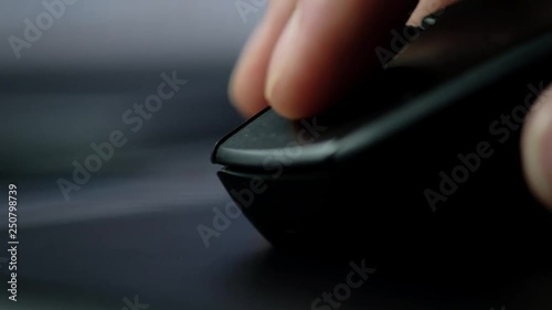 Close-up of male hand clicking mouse.