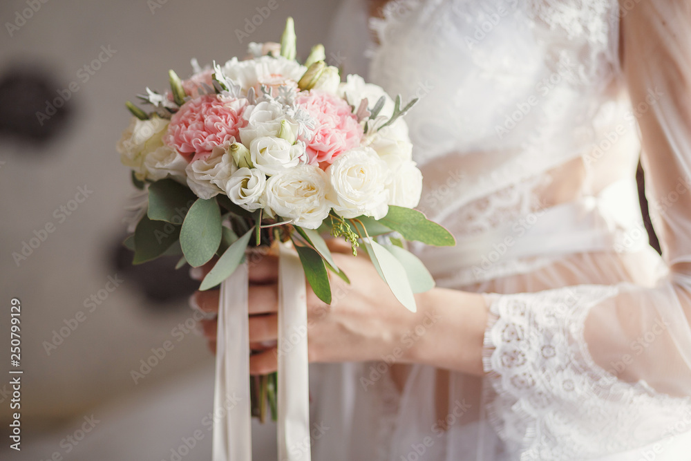 wedding bouquet in bride hands at morning