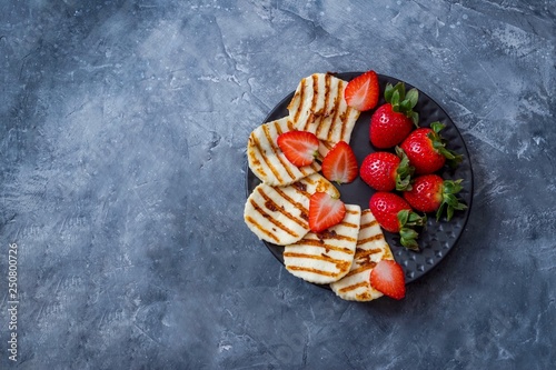 Adyghe cheese on a plate with strawberries.
