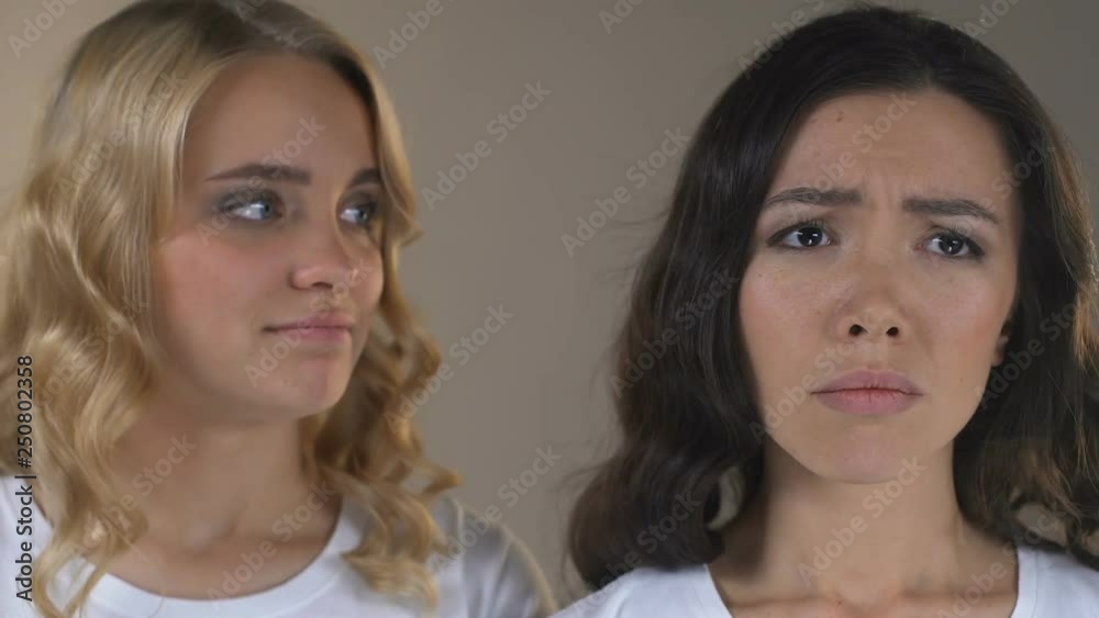 Asian with acne and skin pigmentation is jealous of her friend with healthy face Asian with acne and skin pigmentation is jealous of her friend with healthy face