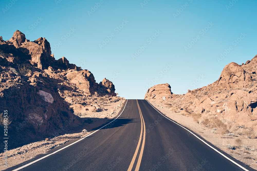 Nevada desert road, color toned travel concept picture, USA.