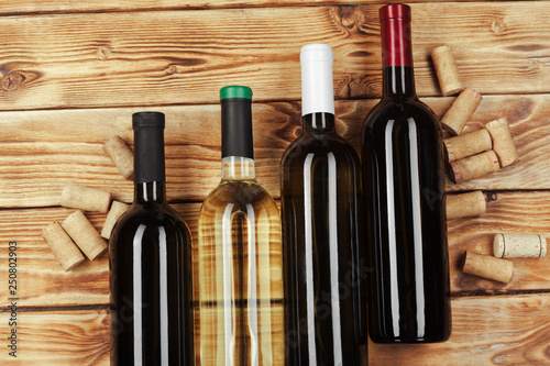 bottle of wine over wooden background