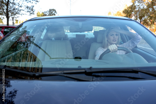 Young blonde woman losing her nerves while driving © didesign