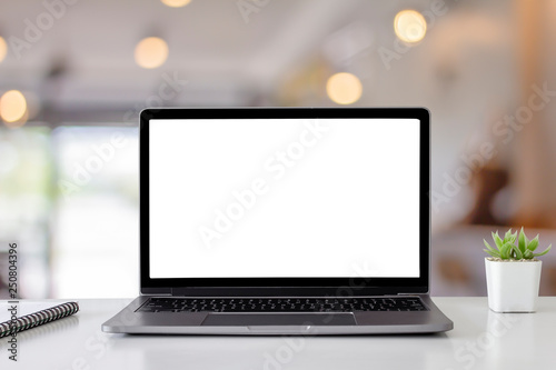 Mockup digital laptop blank white screen on wood table at  coffee shop photo