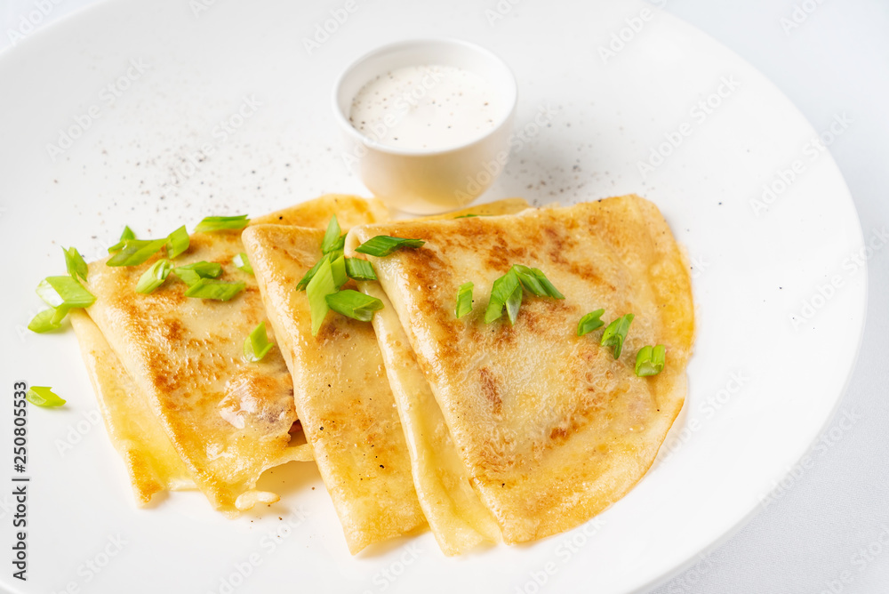 Crepes Suzette with sour cream on the white background Crepes Suzette with sour cream on the white background