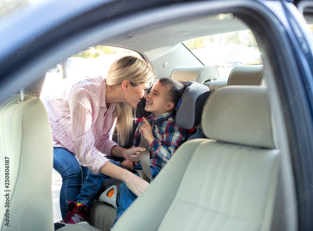 Young boy in the child seat and his mother Young boy in the child seat and his mother