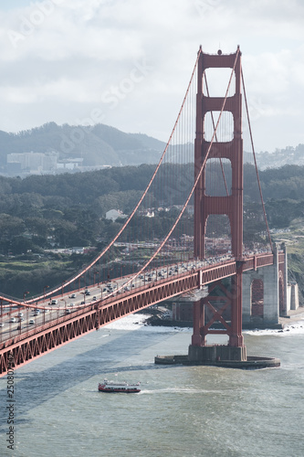 Fotografi Golden Gate bridge in San Francisco with ship underneath - middle of the day, fr