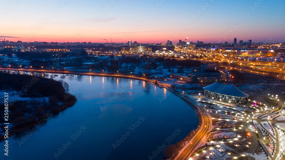 River and city lights early in the morning. Sunrise. Minsk. Belarus. Shooting a quadcopter.