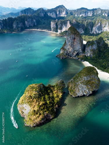 Aerial view of green rocky cliffs and boats on Phra Nang beach bay, Railay beach, in Krabi Province, coastline in Phuket, Thailand. James Bond Island.