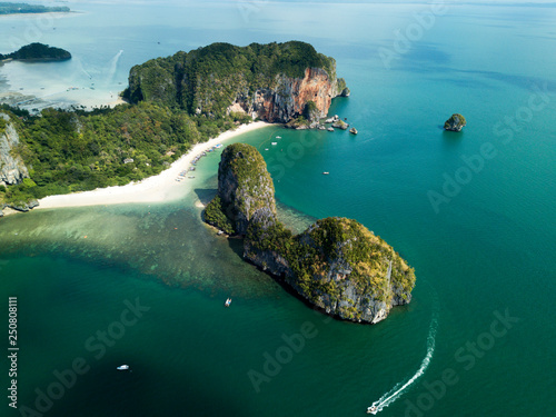 Aerial view of green rocky cliffs and boats on Phra Nang beach bay, Railay beach, in Krabi Province, coastline in Phuket, Thailand. James Bond Island.