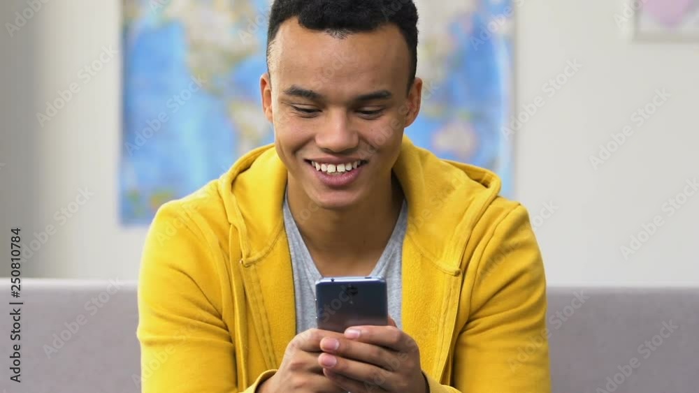 Surprised black high schooler browsing smartphone, modern dating social apps Surprised black high schooler browsing smartphone, modern dating social apps