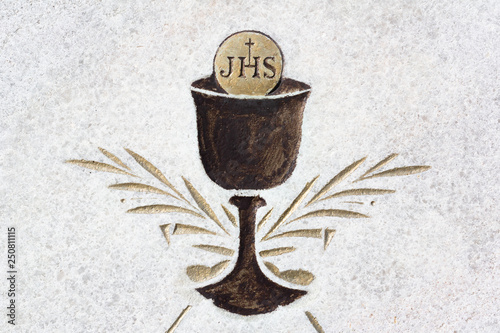 Eucharist - christian sacral ritual with cup, sacramental wine and bread. Icon and pictogram. JHS - Jesus Savior of Mankind