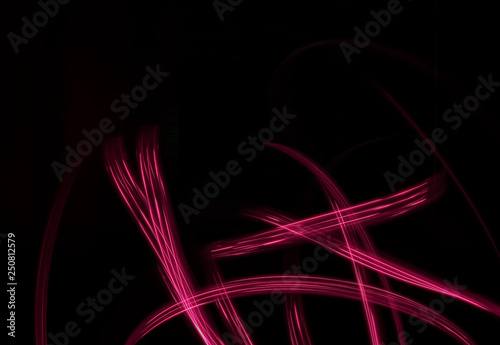 Freeze light photo, made with light painting or light drawing, abstract streaks red color on black background