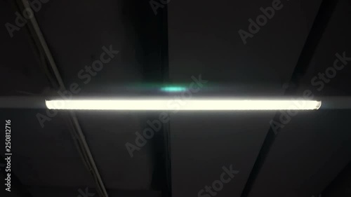 Movement at the bunker in underground corridor with fluorescent lamps on the ceiling
