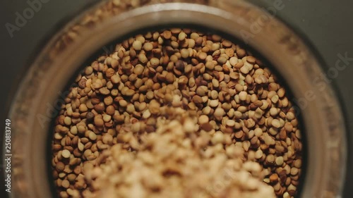 Wallpaper Mural TOP VIEW: Brown lentils grains pouring into a glass jar - Slow Motion Torontodigital.ca