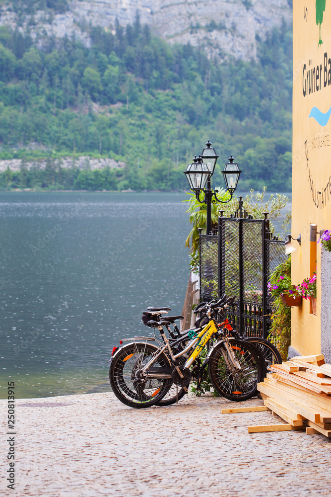 Hallstatt, Austria - May 31, 2018: Bicycles are parked in the parking lot near the lake