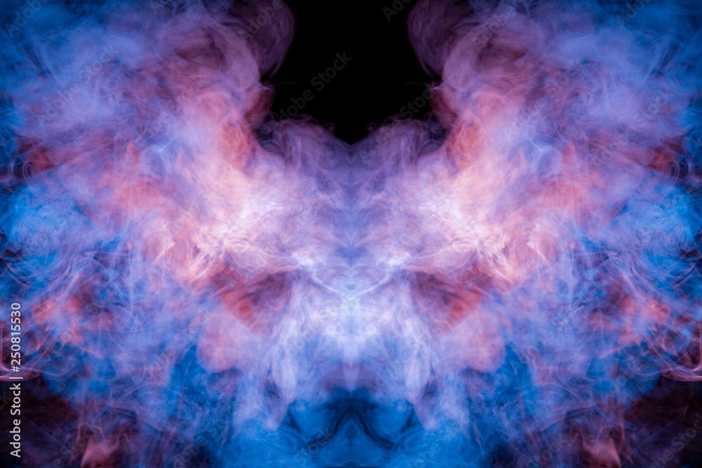 A multi-colored pattern of purple and blue smoke of a mystical shape in the form of a ghost's head or a strange creature on a black isolated background. Abstract pattern in of waves and steam.