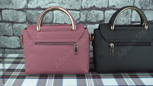 Female pink and black handbags back