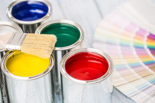 Fototapeta Naklejka Na Ścianę i Meble -  Paint cans brushes and color palette on table