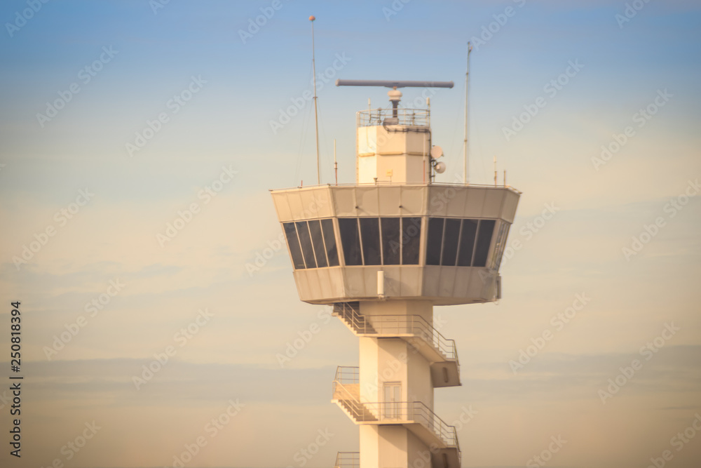 Airplane control tower on the field with blue sky background at