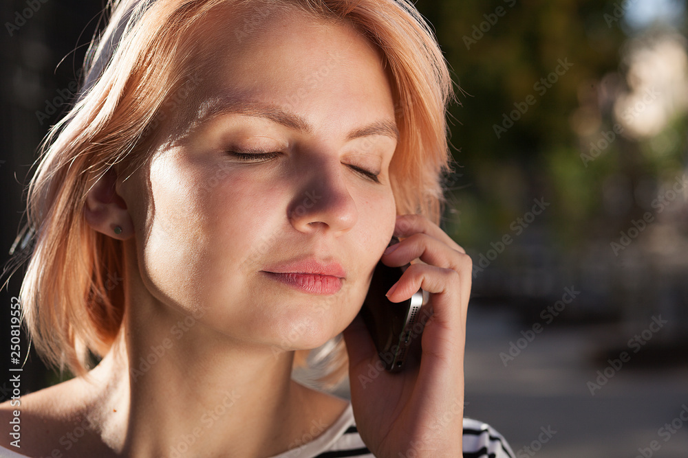 young beautiful girl talking on a cell phone, telephone conversation, walk around the city young beautiful girl talking on a cell phone, telephone conversation, walk around the city