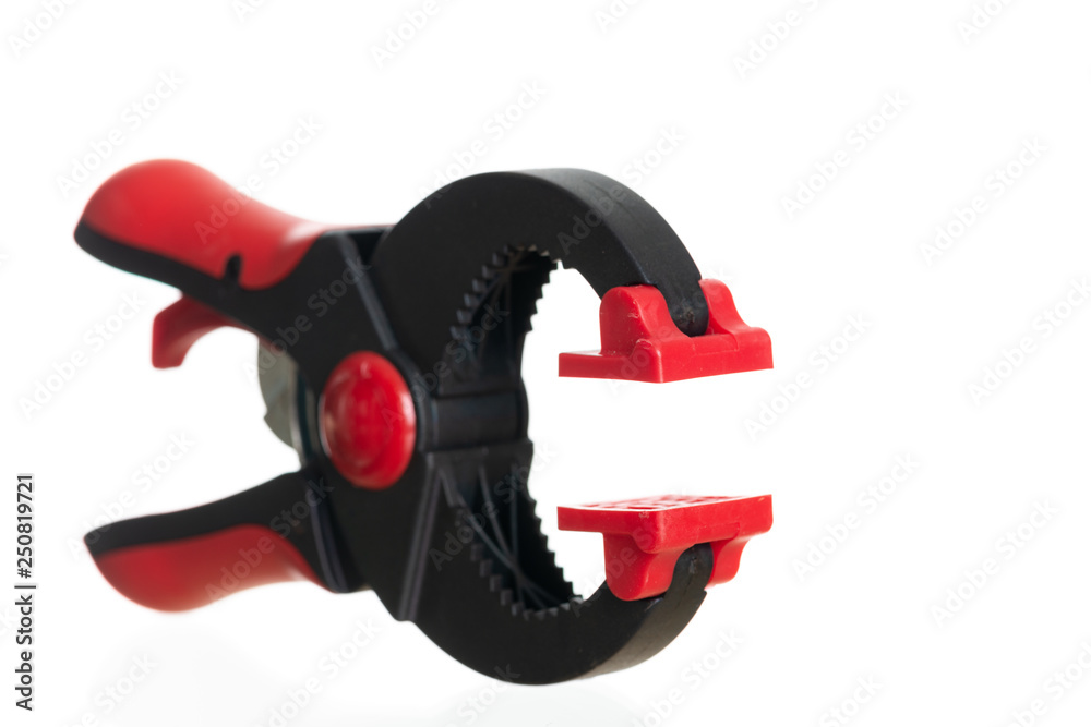 Red and black plastic clamp isolated on white . Red and black plastic clamp isolated on white .