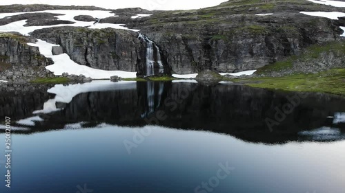 Mountain lake Flotvatnet with waterfall. Scenic region between Aurland and Laerdal in Norway.  National tourist route Aurlandsfjellet photo