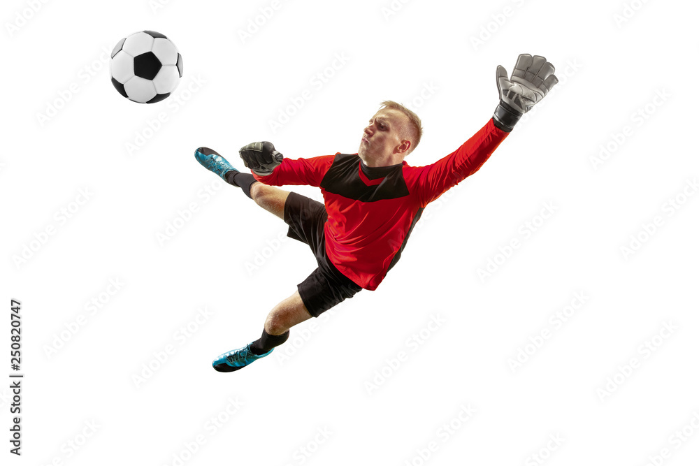 Fototapeta premium Male soccer player goalkeeper catching ball in jump. Silhouette of fit man with ball isolated on white studio background