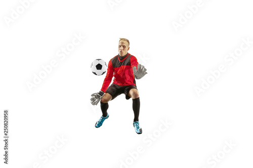 Male soccer player goalkeeper catching ball in jump. Silhouette of fit man with ball isolated on white studio background © master1305