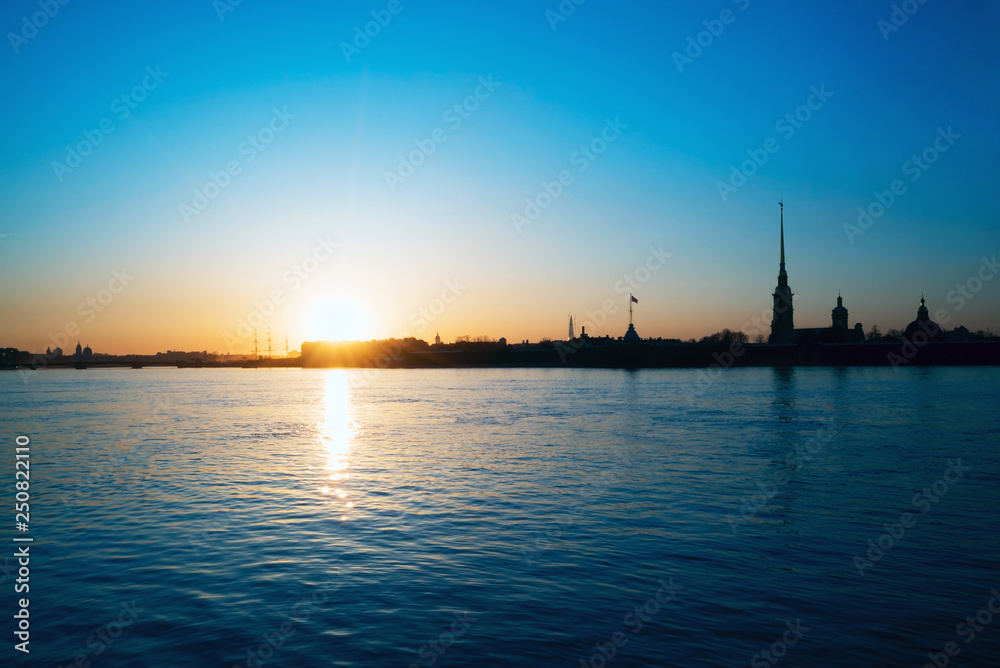 Sunset over the Neva river on the background of Peter and Paul fortress. White night. Saint-Petersburg.