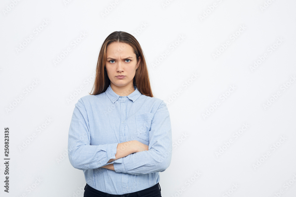 angry young woman standing with arms crossed angry young woman standing with arms crossed