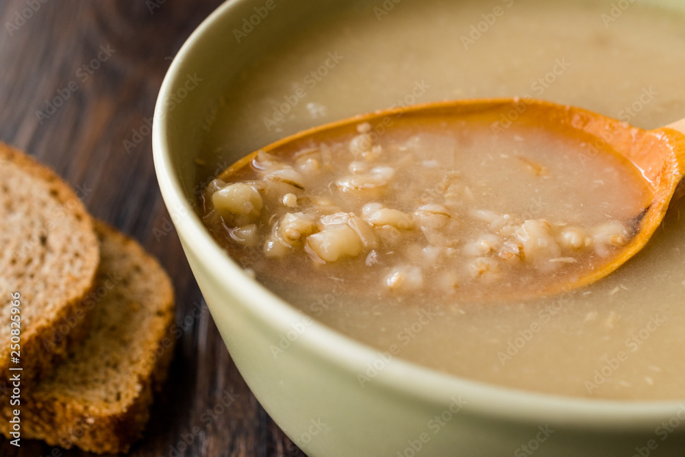 Wheat Soup with Chicken Broth Bouillon on Dark Wooden Surface. Wheat Soup with Chicken Broth Bouillon on Dark Wooden Surface.