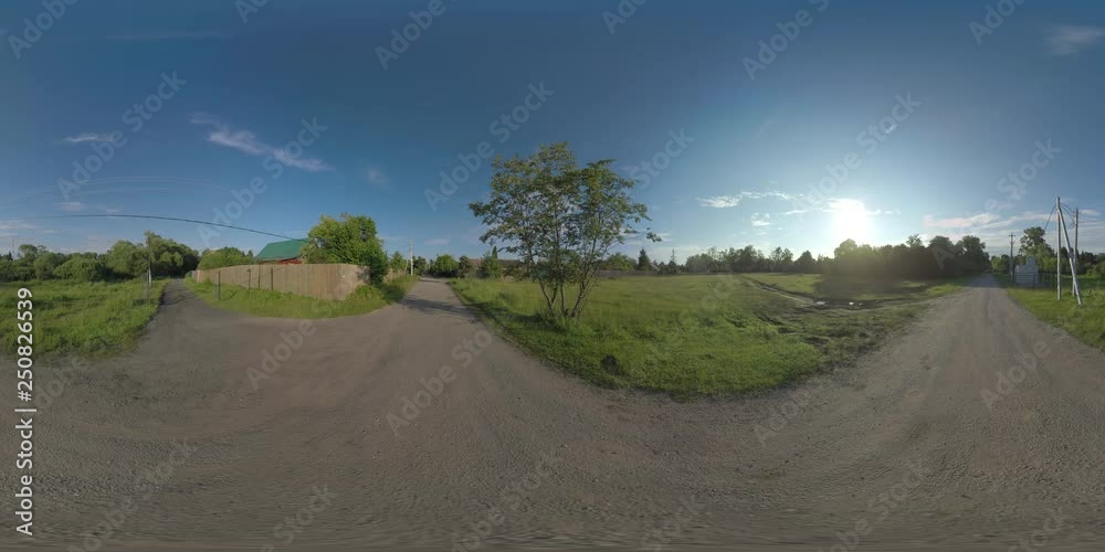 360 VR Video. In the countryside. View to the private houses, country roads with a car passing by and forest in bright sunlight 360 VR Video. In the countryside. View to the private houses, country roads with a car passing by and forest in bright sunlight
