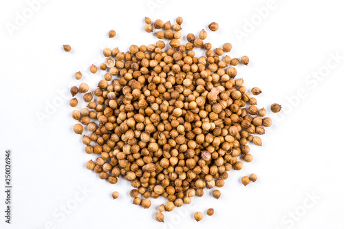 heap of coriander seeds isolated on white background. top view