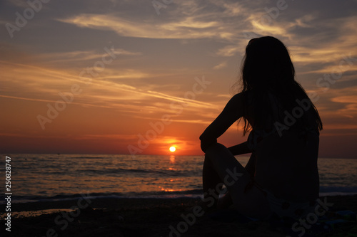 Beautiful woman on the beach at sunset. Woman enjoy on the beach in Greece